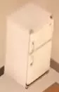 White refrigerator with separate freezer and fridge doors.